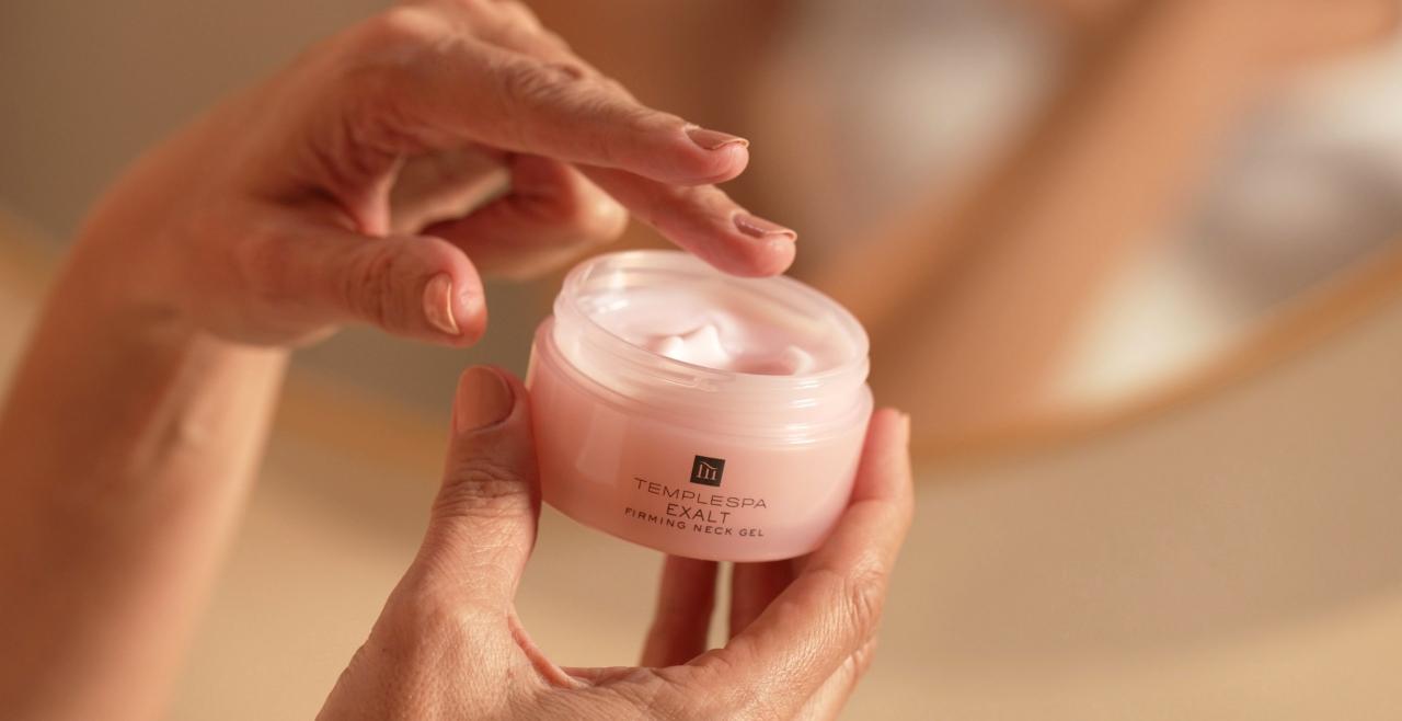 Hands holiday exalt our firming neck gel and showing texture in tub