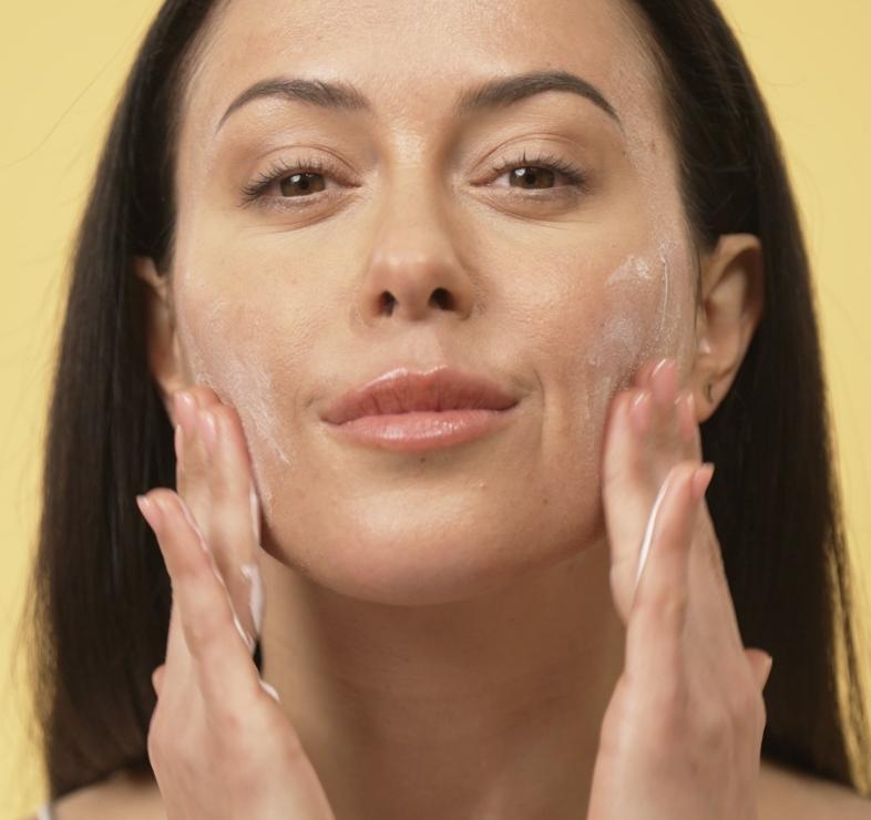 Lady applying spf to her face