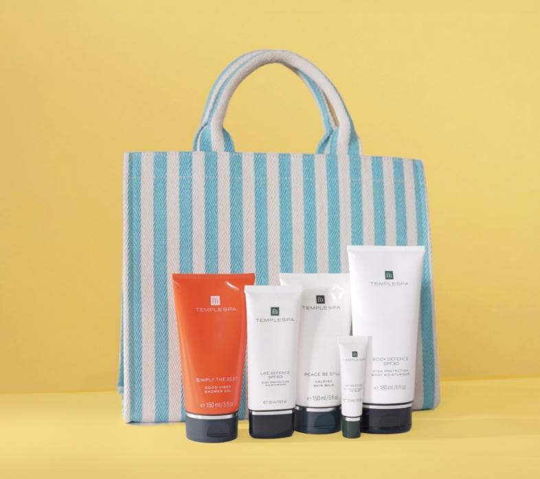 Our sunny skies gift, five products in a blue stripey canvas bag. Products include, simply the best, life defence spf50, peace be still, lip defence and body defence spf30