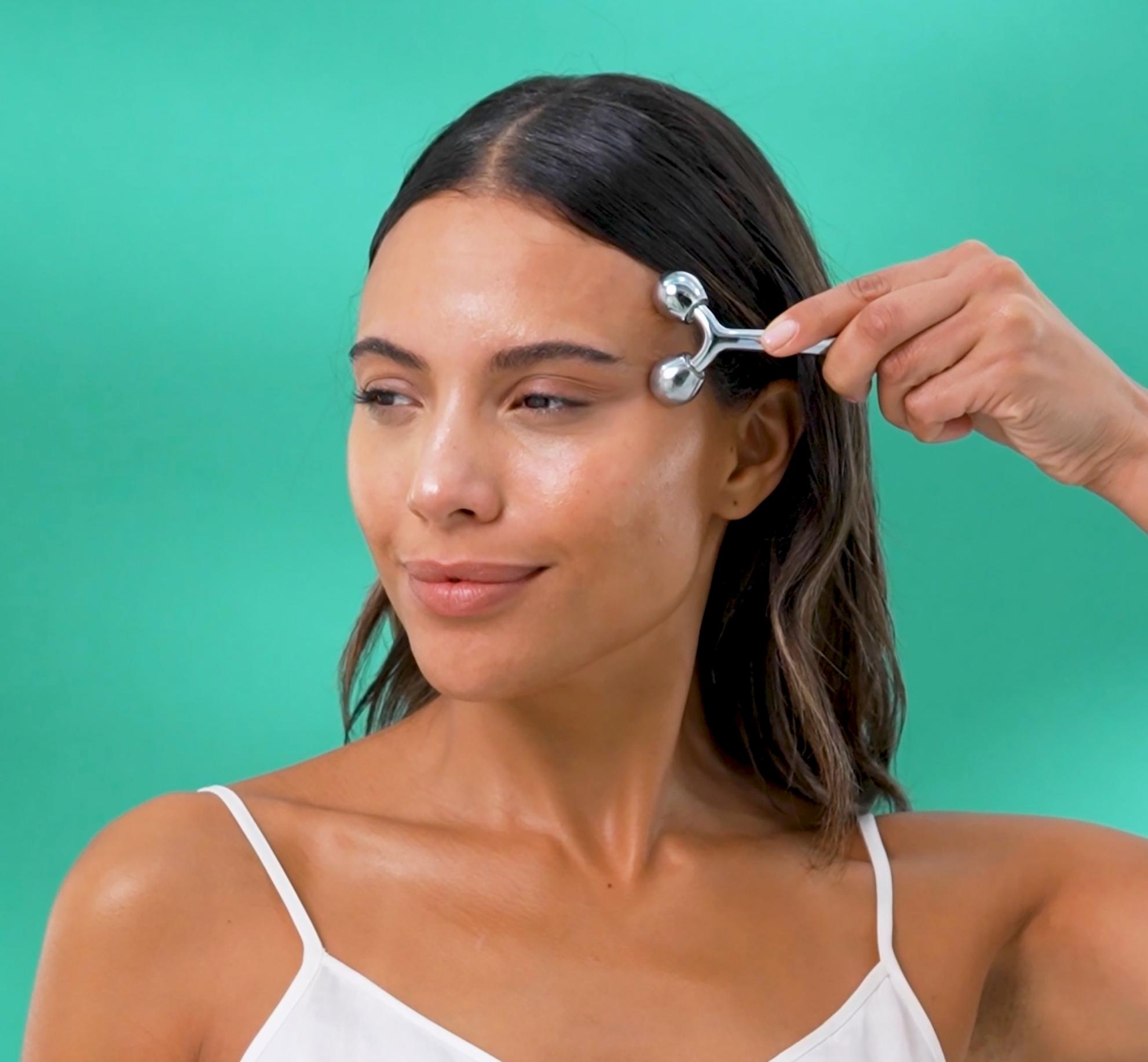 Model using face massage tool