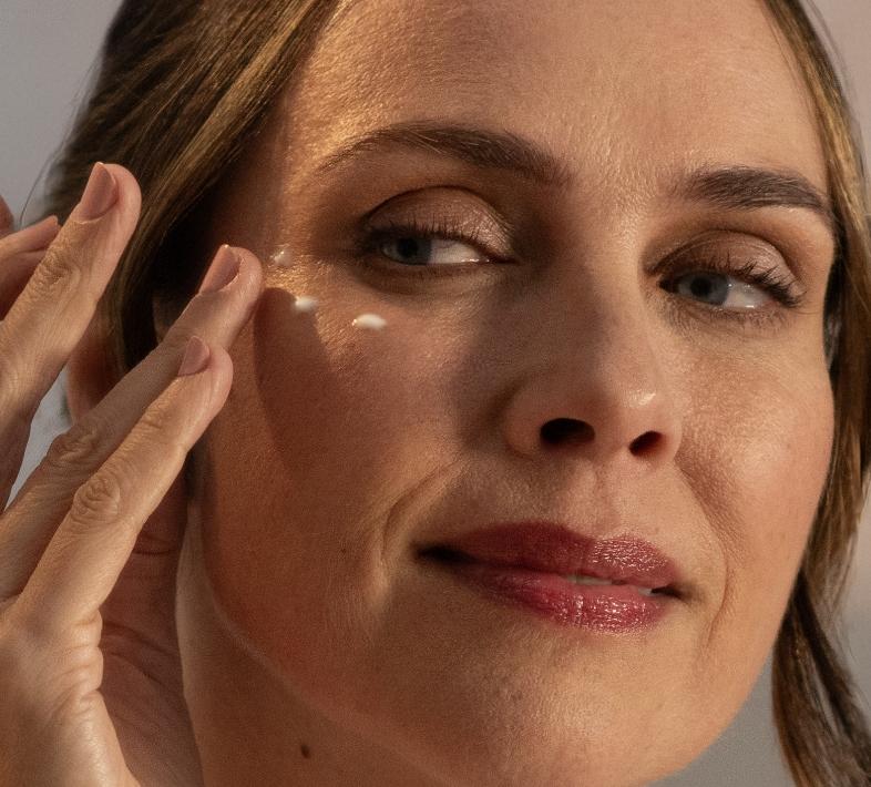 lady applying windows of the soul to her face with her fingertips
