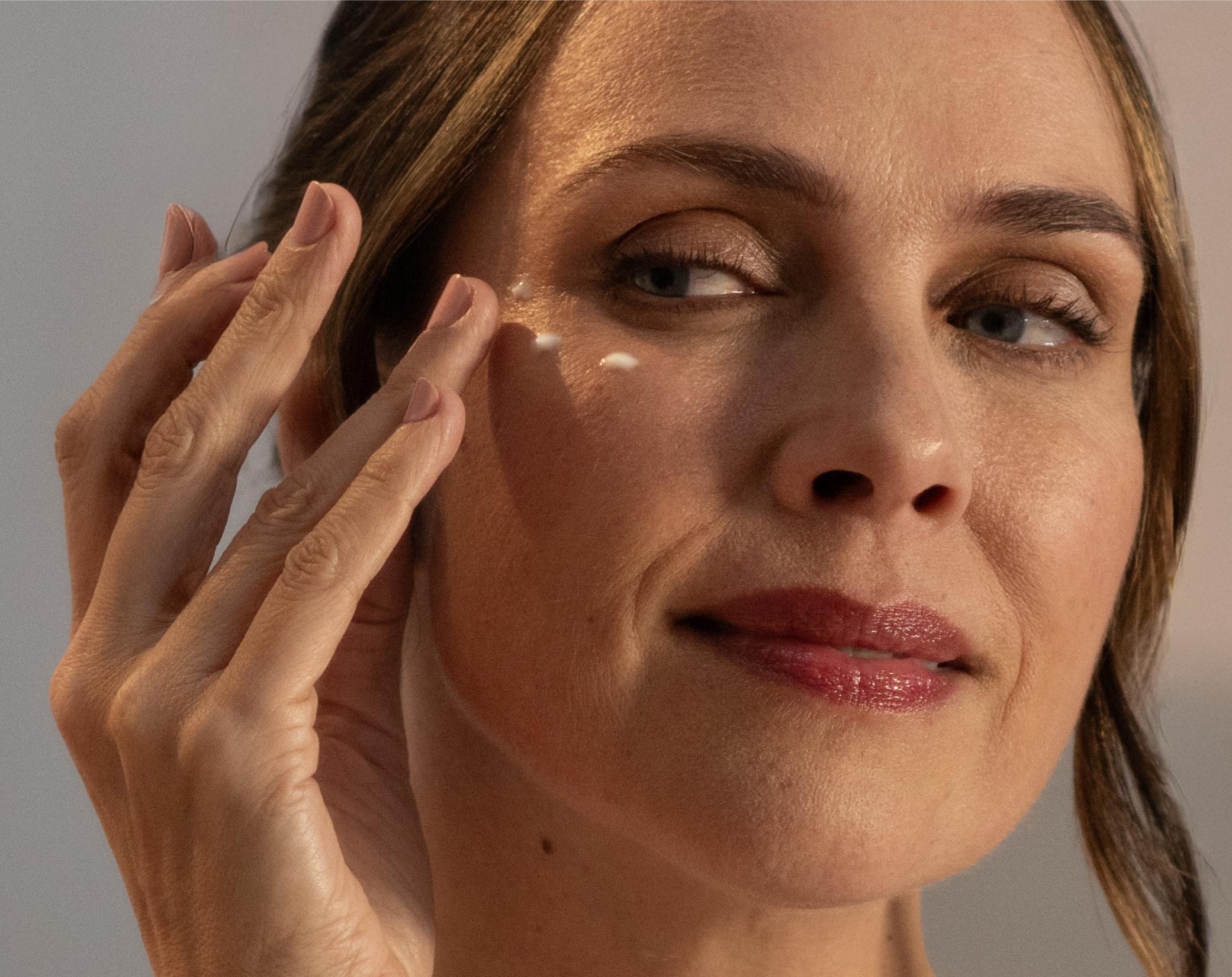 lady applying windows of the soul to her face with her fingertips