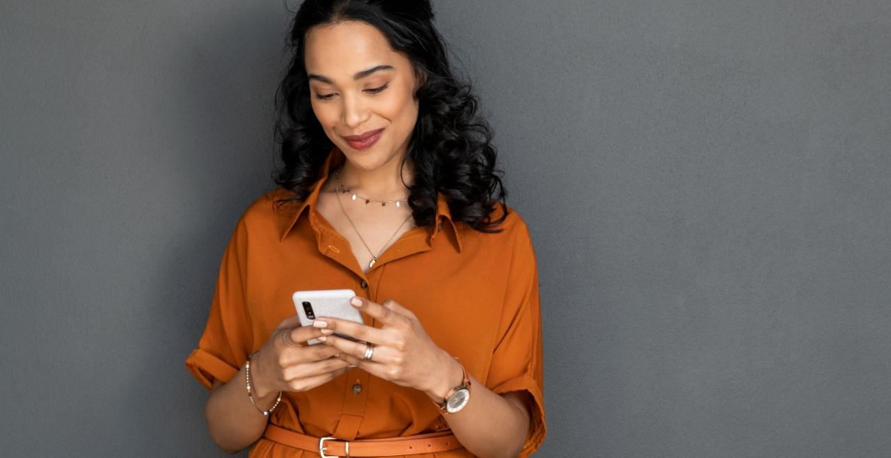 Lady smiling and looking down at her phone